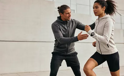 Eine sportliche Frau beim Lauftraining mit ihrem Trainer